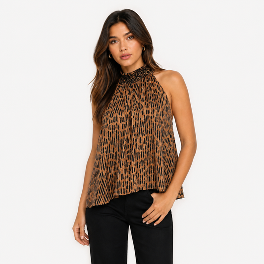Alice & Olivia M leopard print halter blouse with smocked neckline and open-back tie detail.