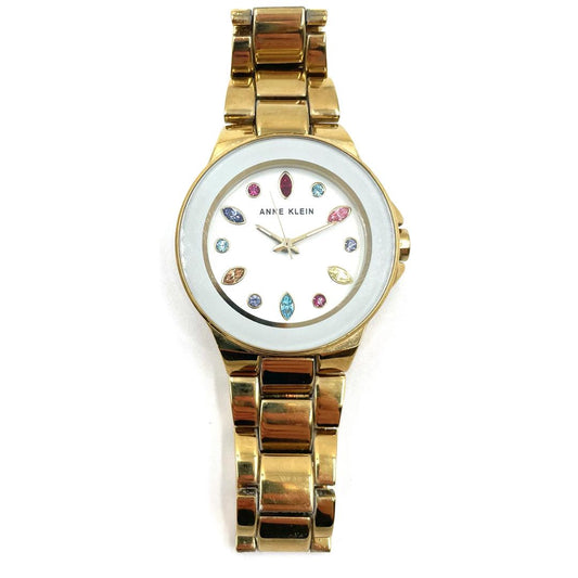 Anne Klein gold-tone bracelet watch with a white dial and multicolor crystal hour markers.