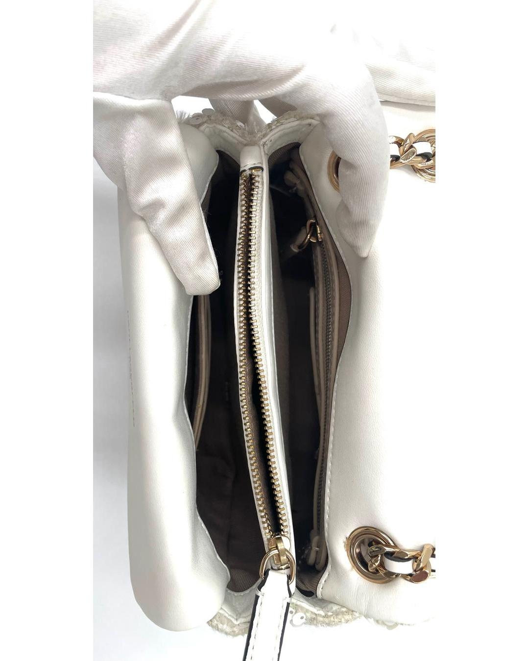 Interior view of a cream Karl Lagerfeld sequin bag featuring a central zip compartment and gold chain strap details.