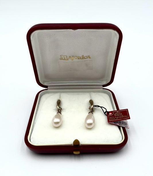 Majorica pearl drop earrings with gold-tone findings in a red velvet box, 1.5" long.