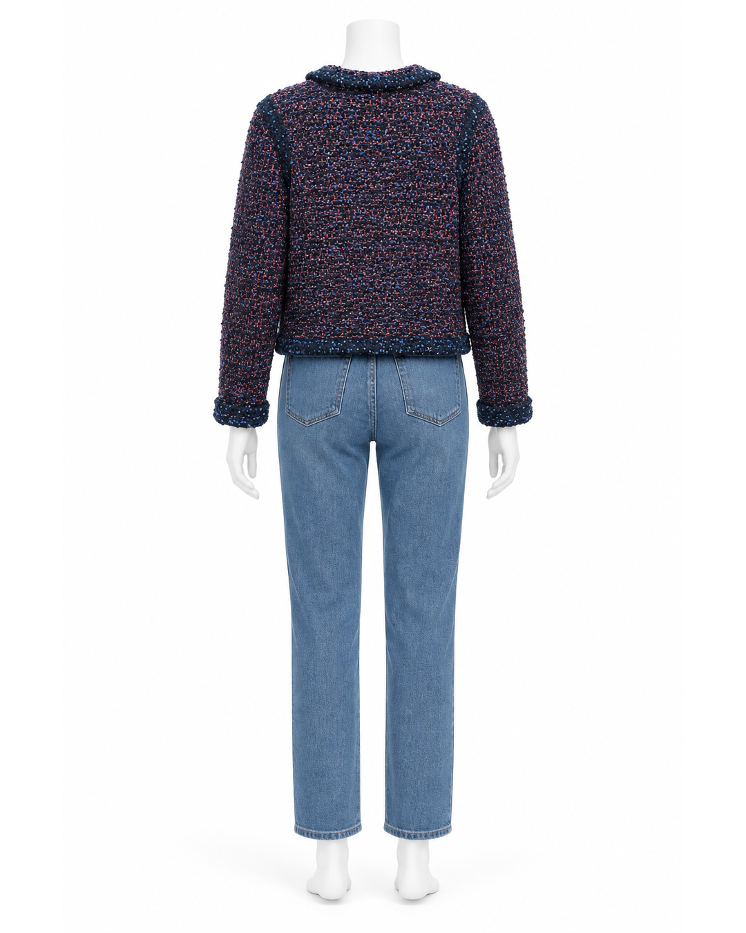 Back view of a Missoni multicolor navy tweed cropped blazer with bouclé trim, worn with blue jeans on a mannequin.