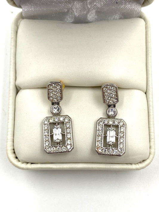 Silver-toned cubic zirconia small drop earrings with rectangular faux diamond centers, displayed in a white box.