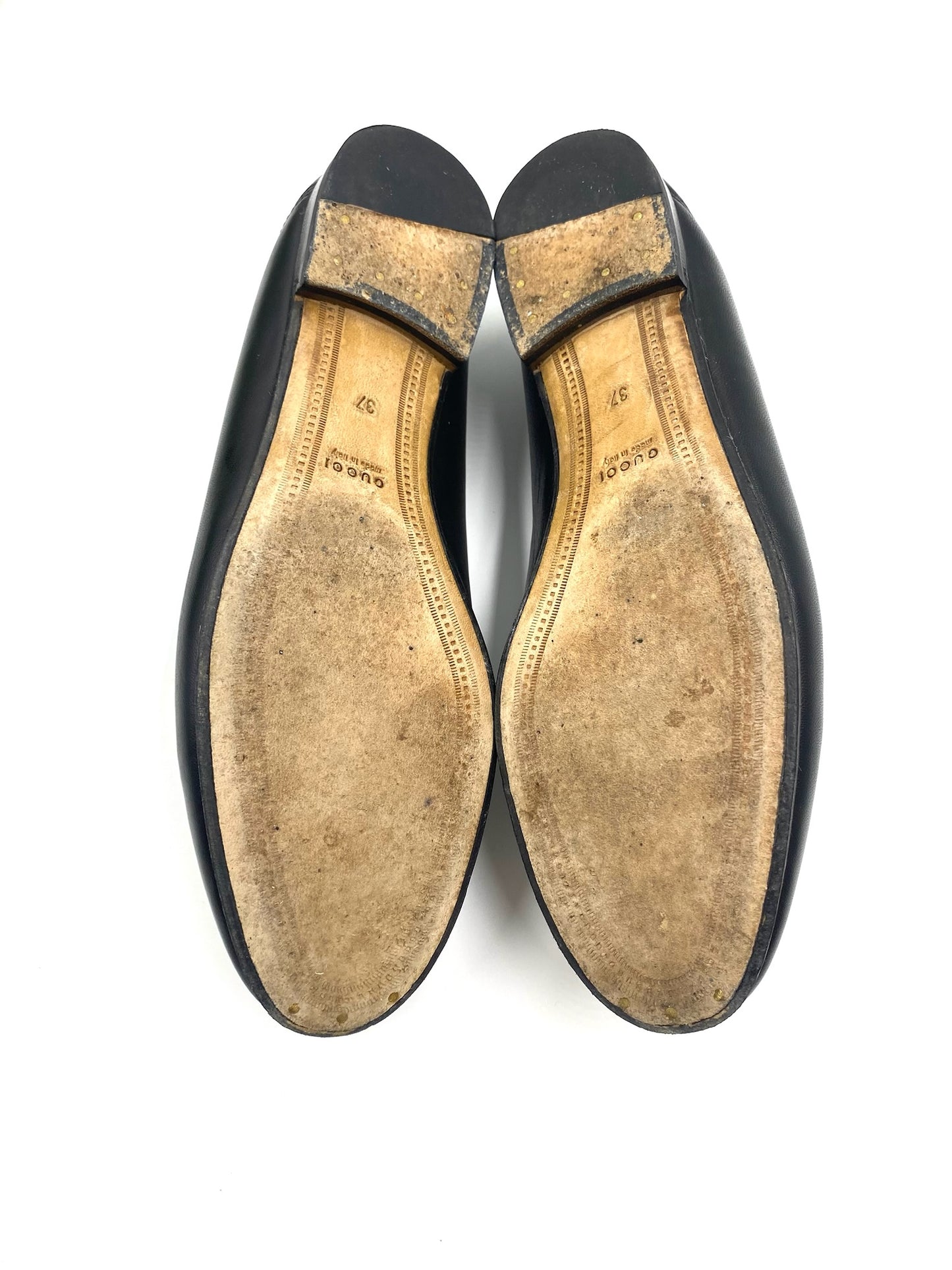 Gucci Black Jordaan Loafers size 37, showing worn soles with "Gucci Made in Italy" stamp.