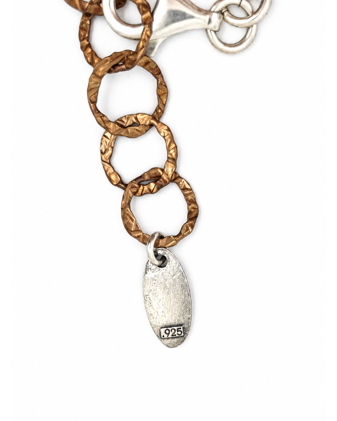 Karyn Chopik mixed metal necklace featuring hammered bronze-tone links and a silver designer tag with a .925 hallmark.