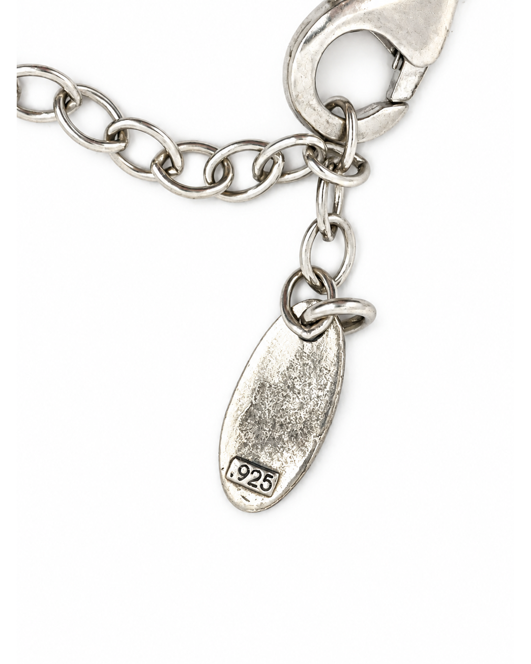 Karyn Chopik silver chain necklace featuring a lobster clasp and a textured oval tag with a .925 hallmark.