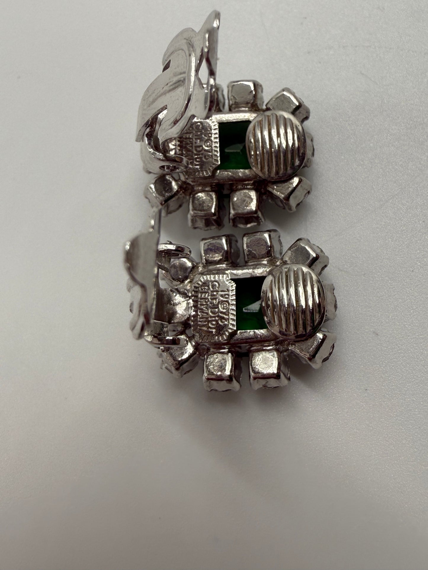 Rare 1973 Christian Dior silver-tone clip earrings with emerald glass cabochons and clear crystal rhinestones.