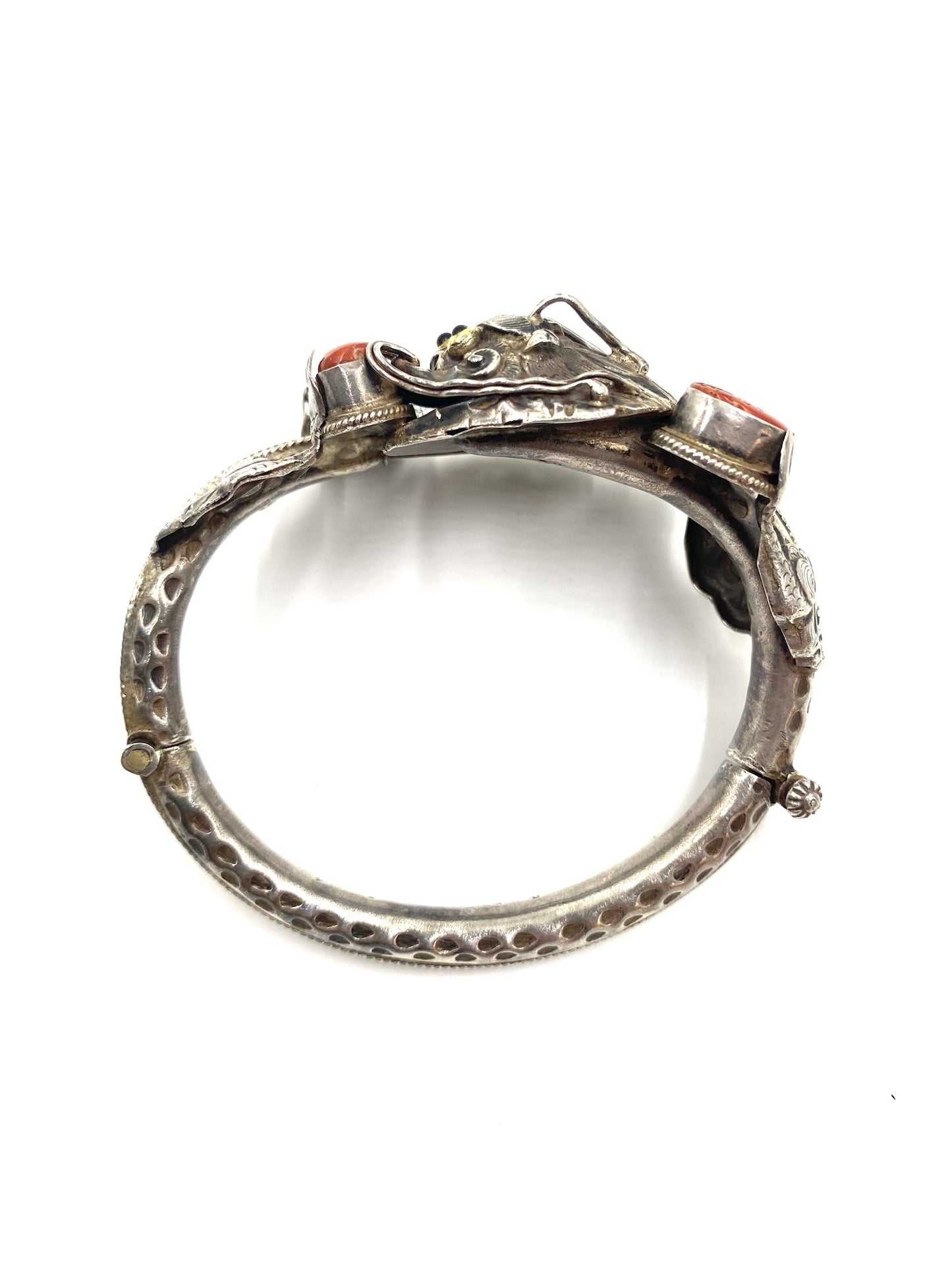 Sculpted sterling silver dragon bracelet with red coral cabochons and high-relief details.