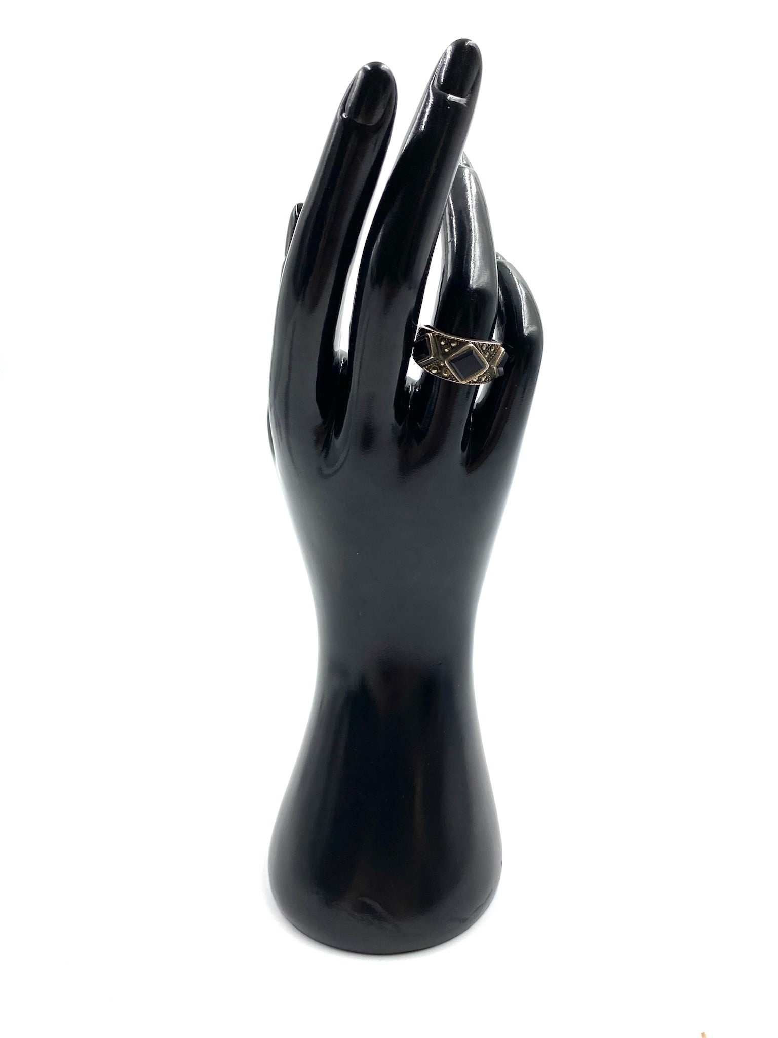 Black Onyx Sterling Silver Ring, size 7, with a dark stone and silver band, displayed on a black hand model.