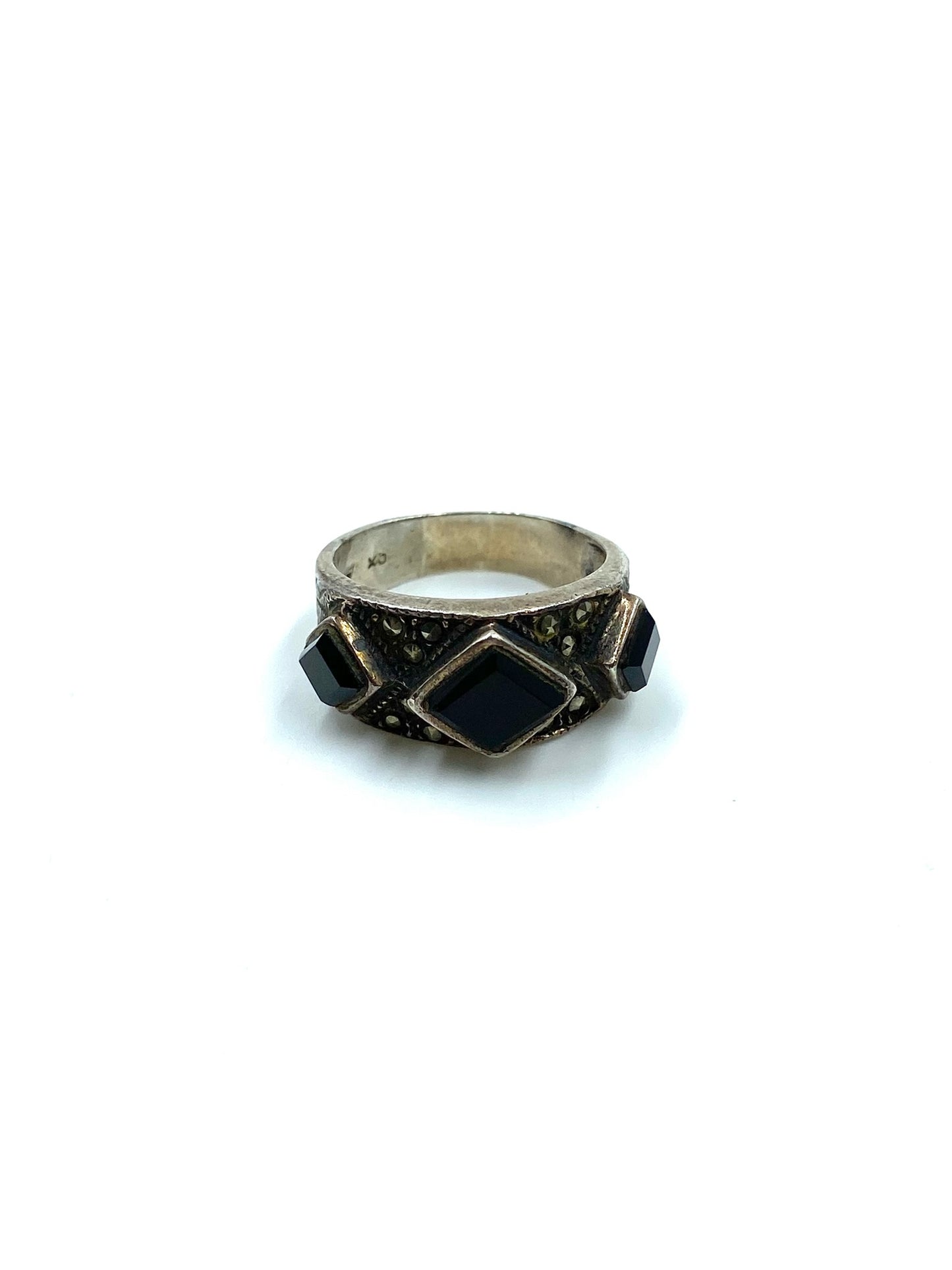 Sterling silver ring with three black onyx stones: a central diamond shape flanked by two smaller ones.
