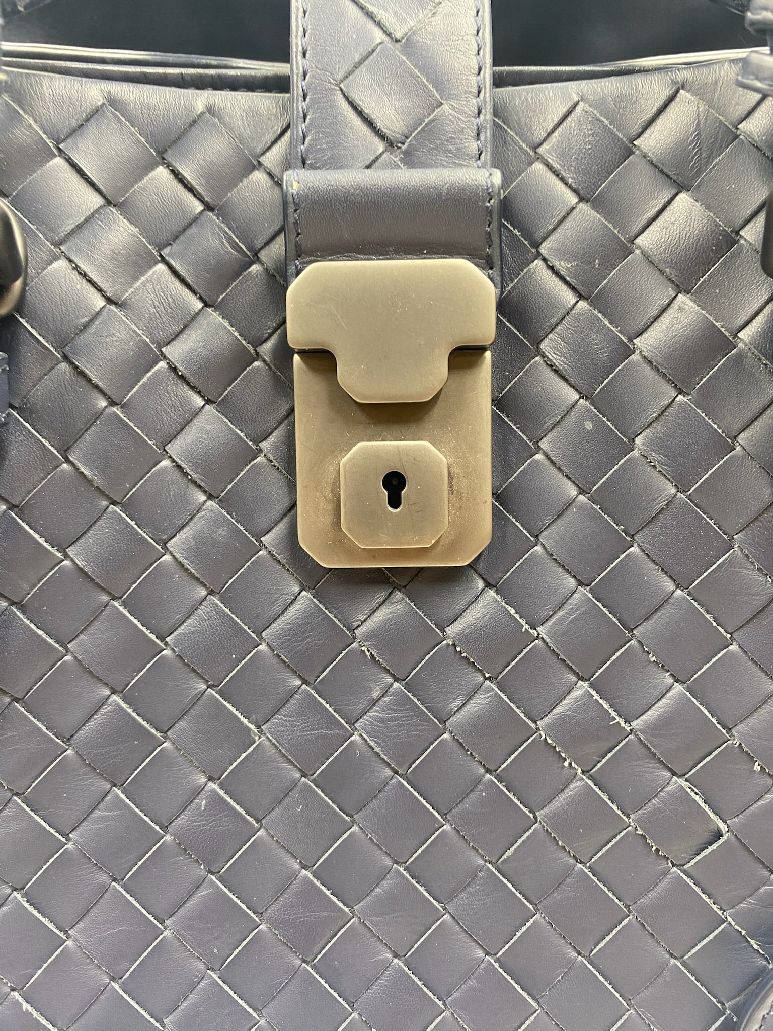 Bottega Veneta blue Intrecciato leather Roma bag with gunmetal padlock closure.