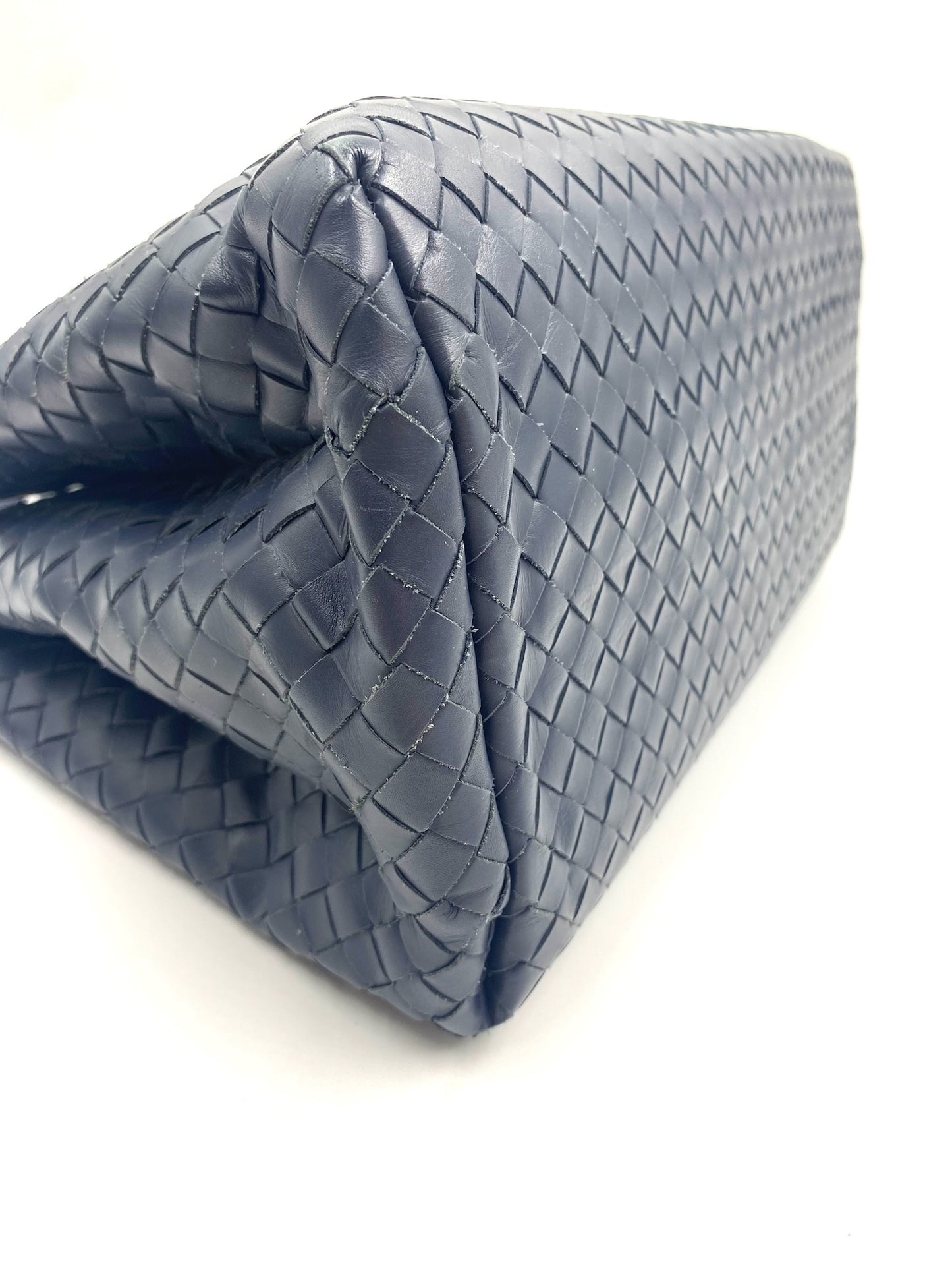 Bottega Veneta blue Intrecciato leather small Roma bag, showing woven texture and side profile.