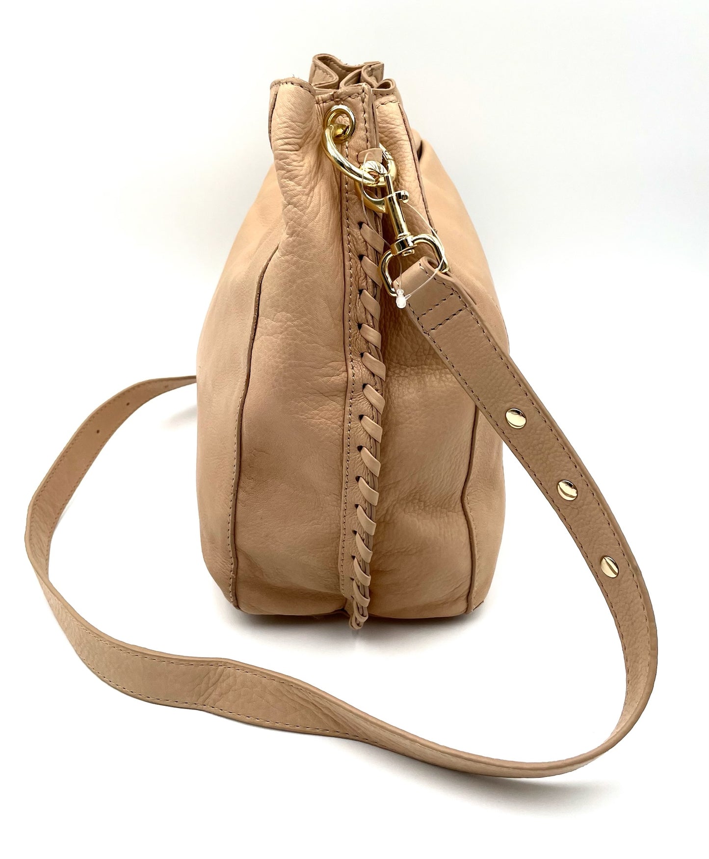 Beige leather shoulder bag with gold hardware, braided side detail, and adjustable crossbody strap.