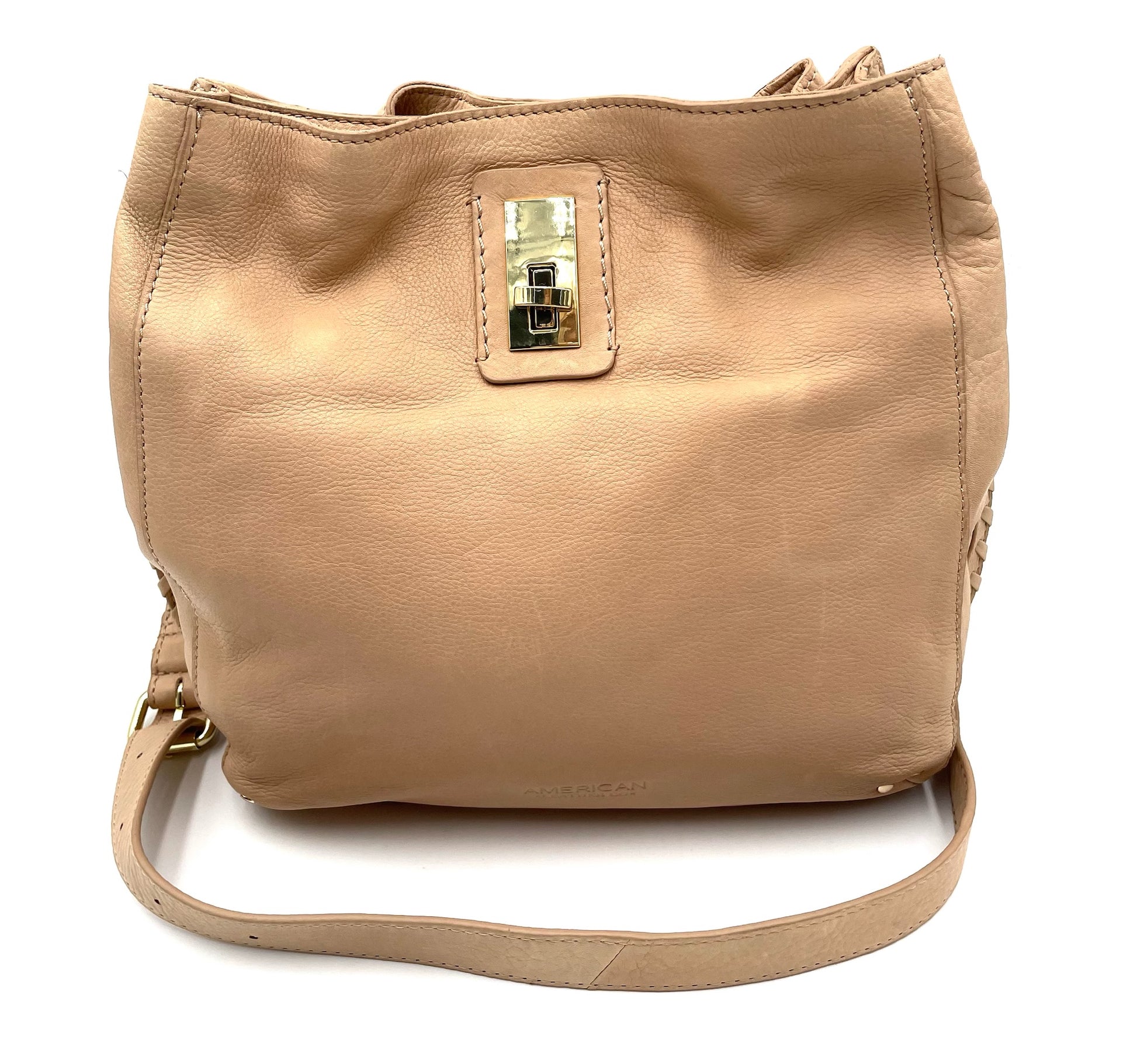 Beige leather shoulder bag with gold-tone hardware, braided sides, and an adjustable strap.