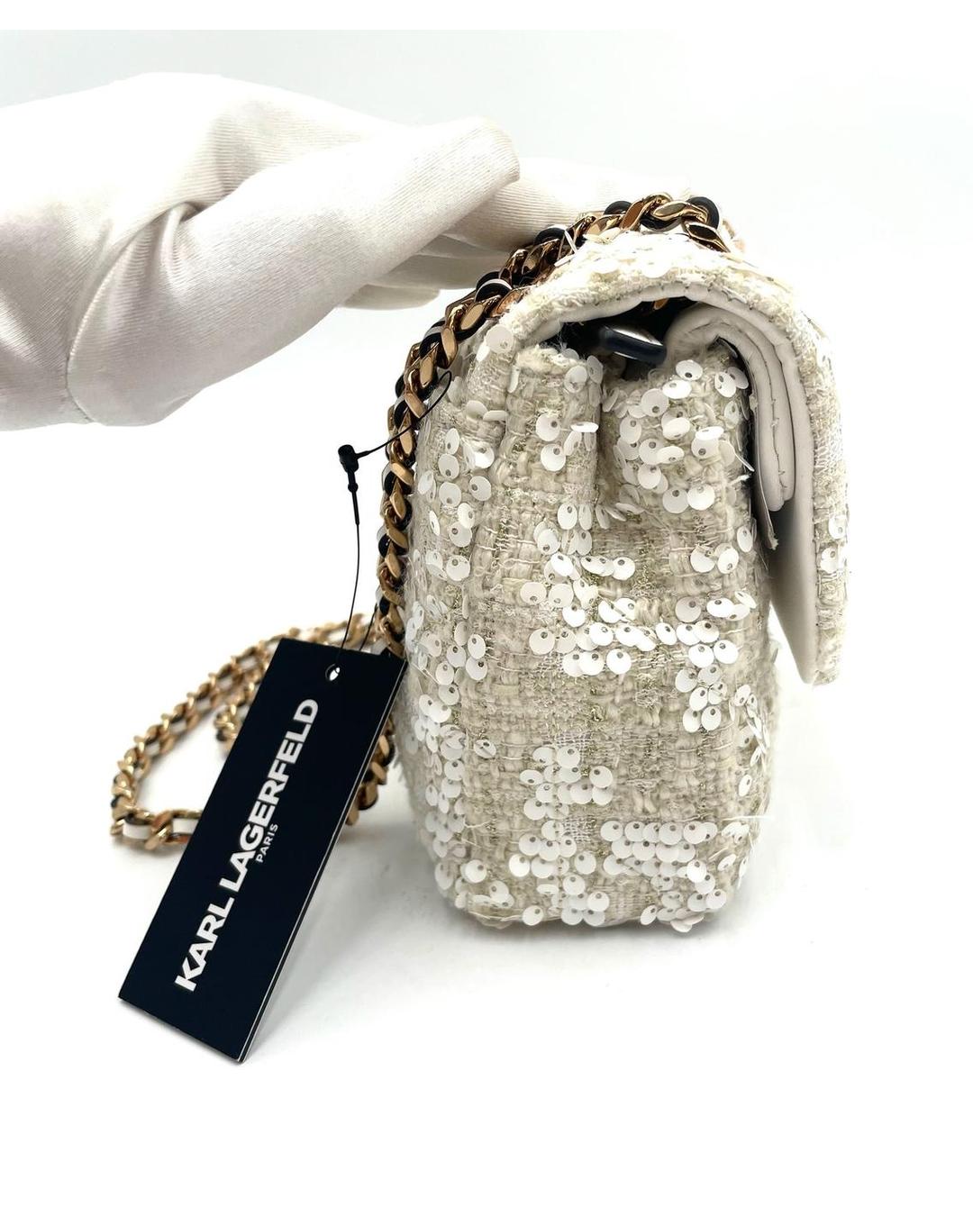 Karl Lagerfeld cream sequin crossbody bag with gold chain strap and brand tag.