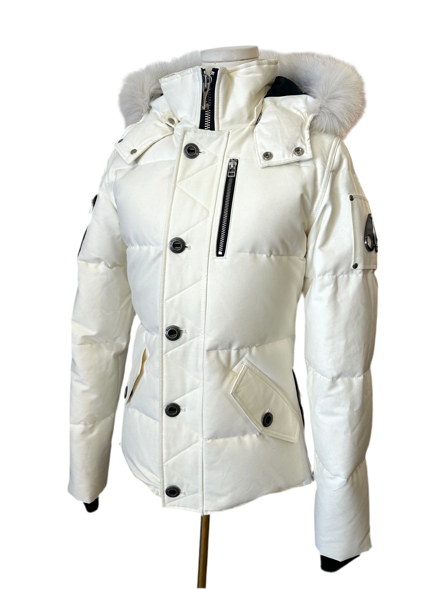 Brand New Moose Knuckle Women's White Down Puffer Jacket, size XS, with fur-trimmed hood and black zippers.
