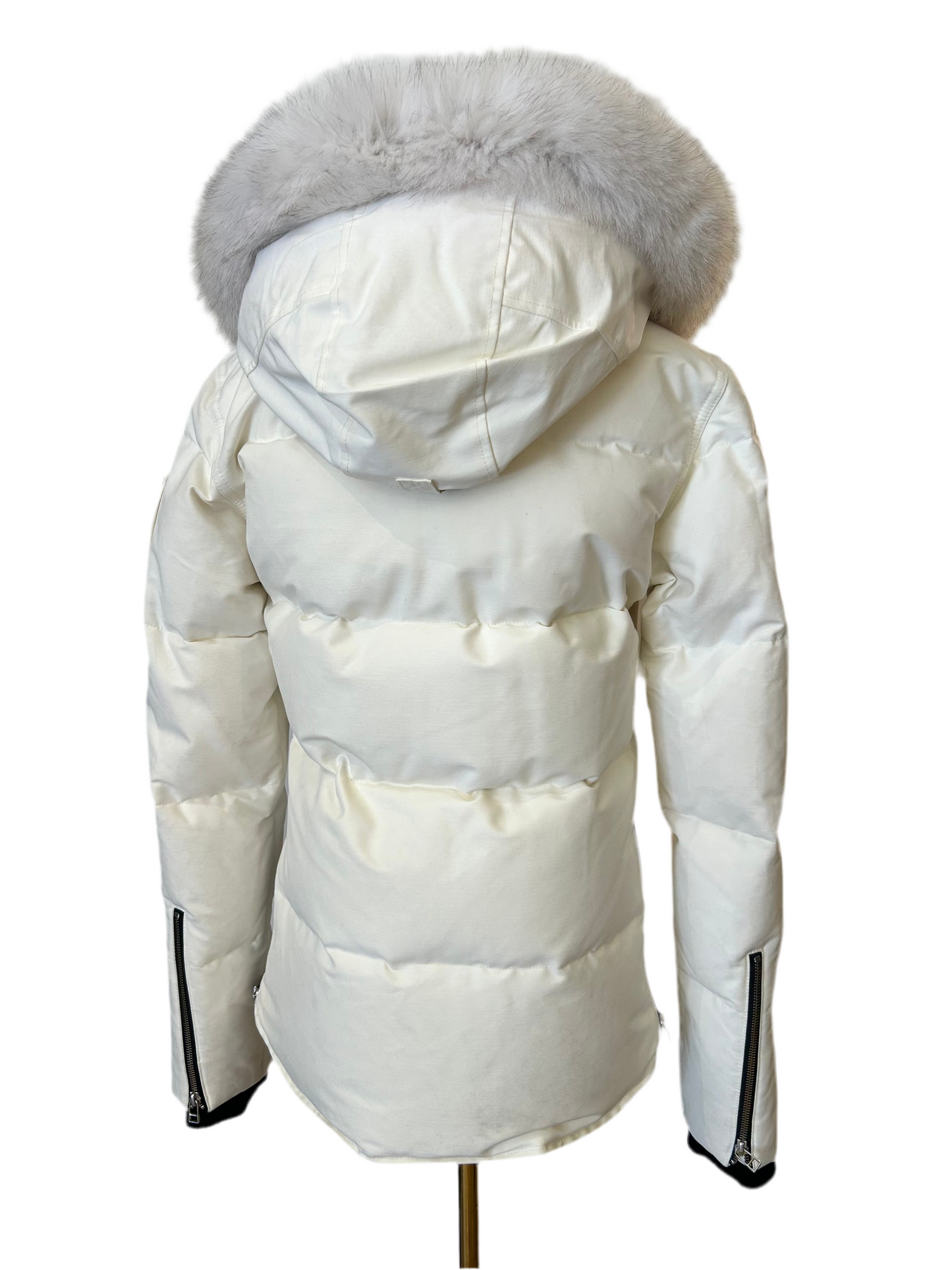 Moose Knuckle Women's White Down Puffer Jacket, size XS, with a light grey fur-trimmed hood and zippered cuffs.