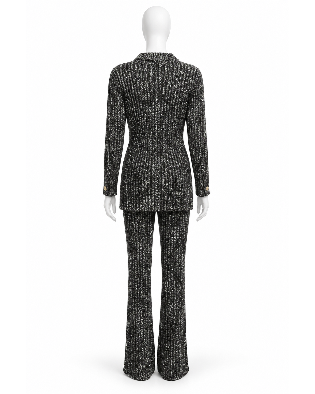 Back view of a St. John black and white knit sweater and wide-leg pant set, size L, on a mannequin.