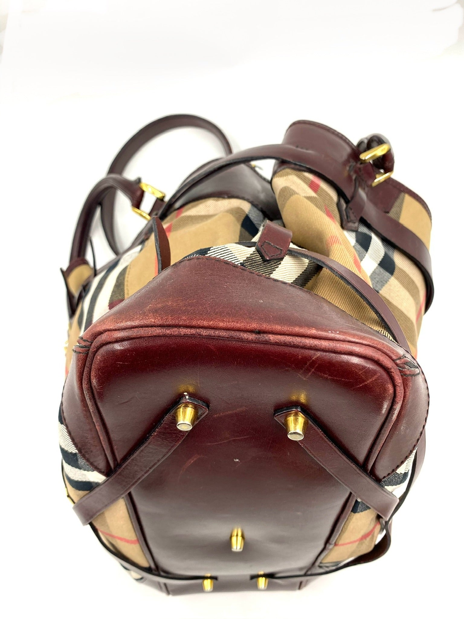 Burberry Burgundy Leather Bridle House Check Tote, showing bottom with brass feet and leather trim.