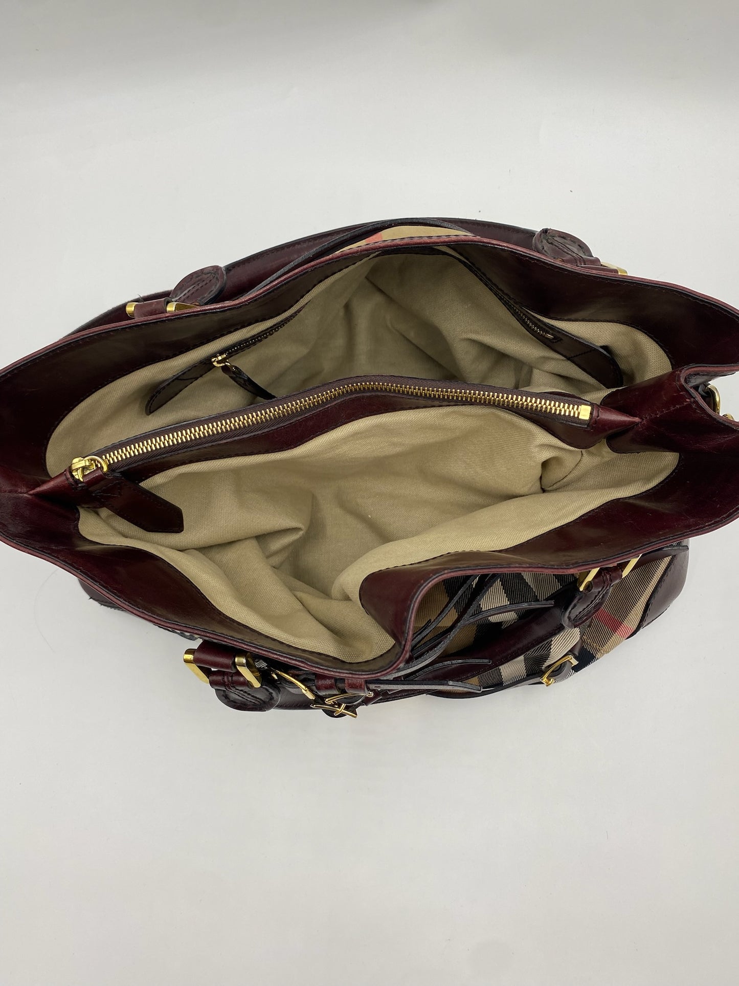 Burberry Burgundy Leather Bridle House Check Tote with open top, beige fabric interior, and brass hardware.