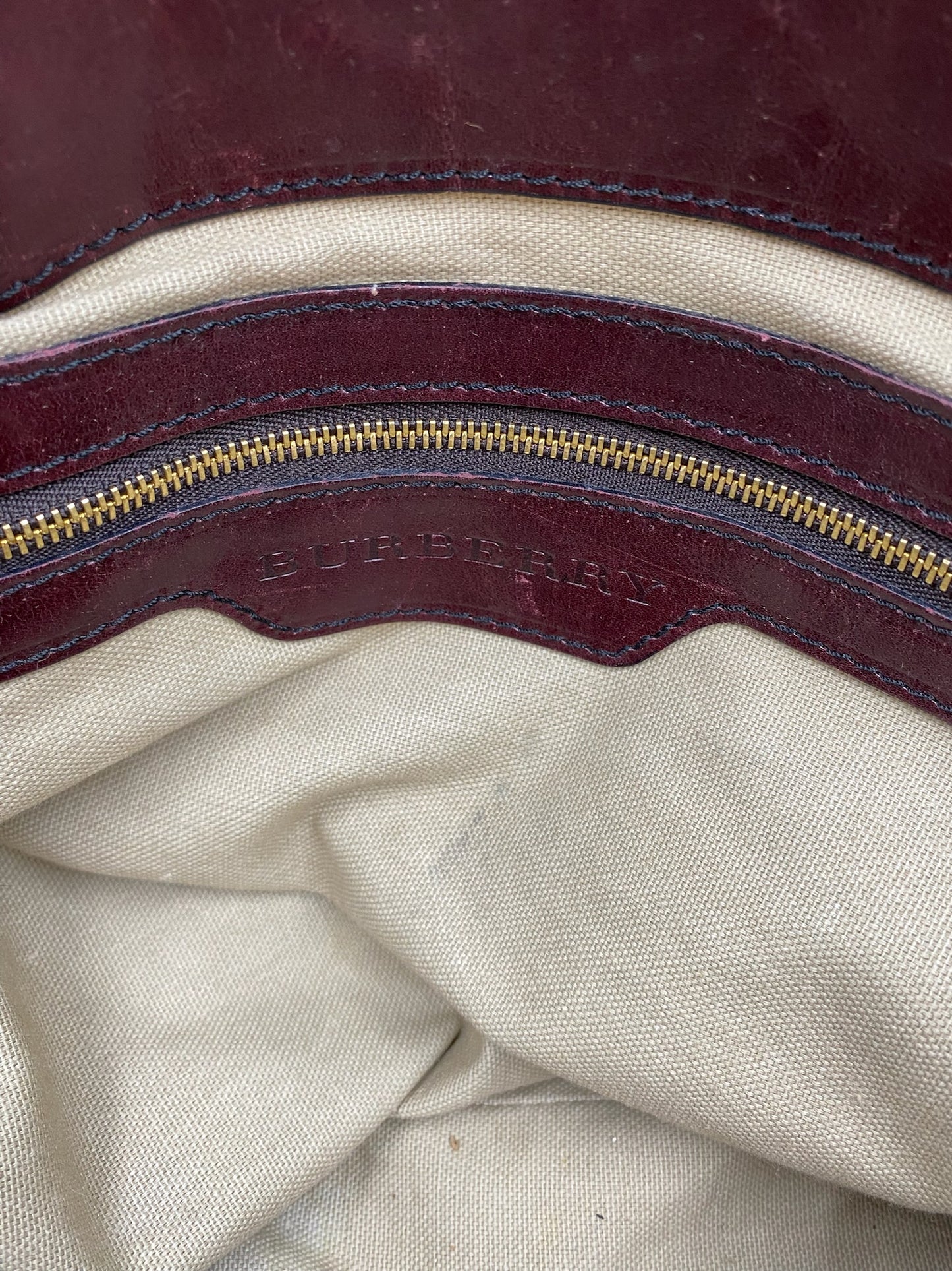 Burberry Burgundy Leather Bridle House Check Tote interior with gold zipper and embossed logo.