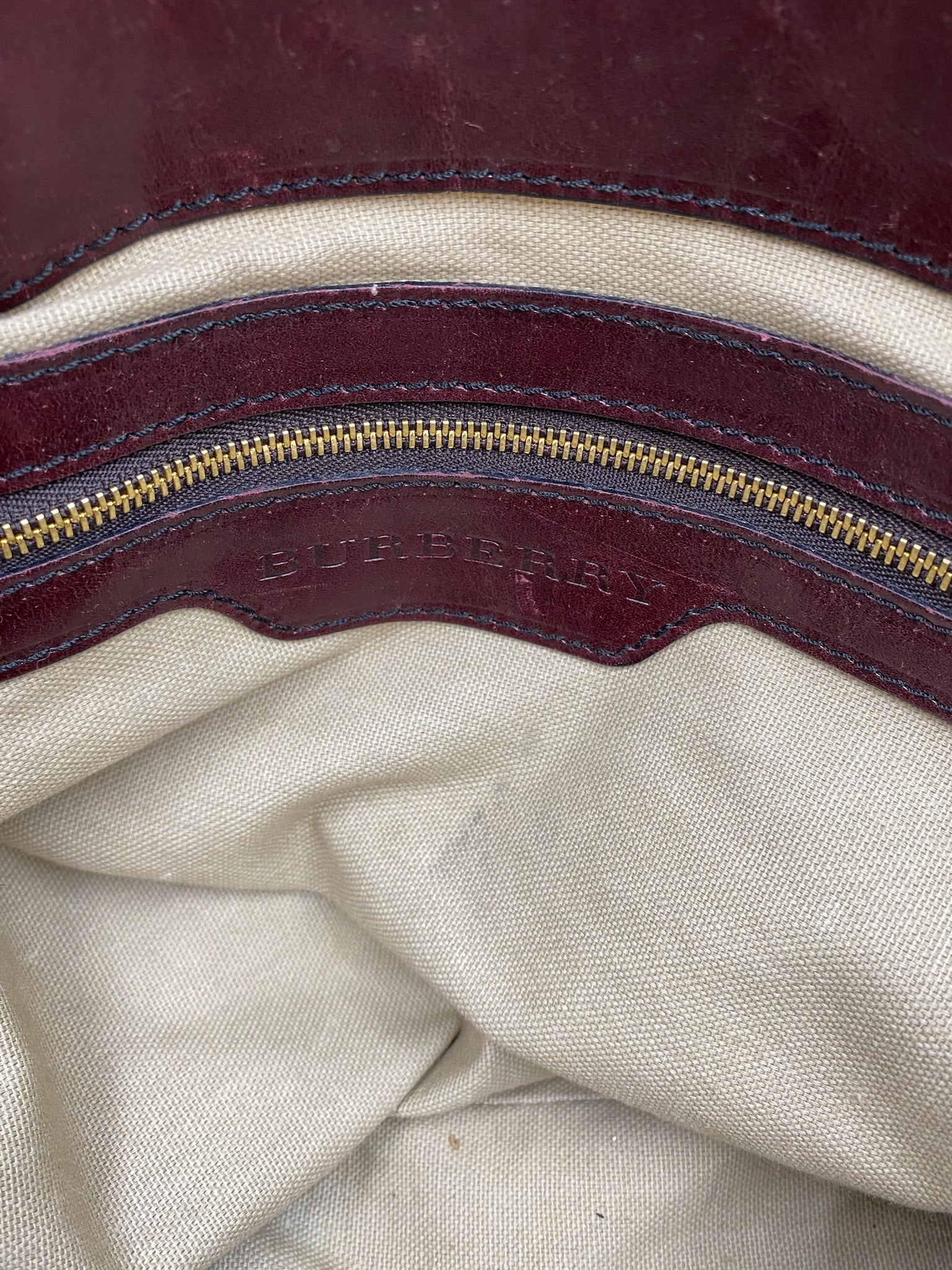 Burberry Burgundy Leather Bridle House Check Tote interior with gold zipper and embossed logo.