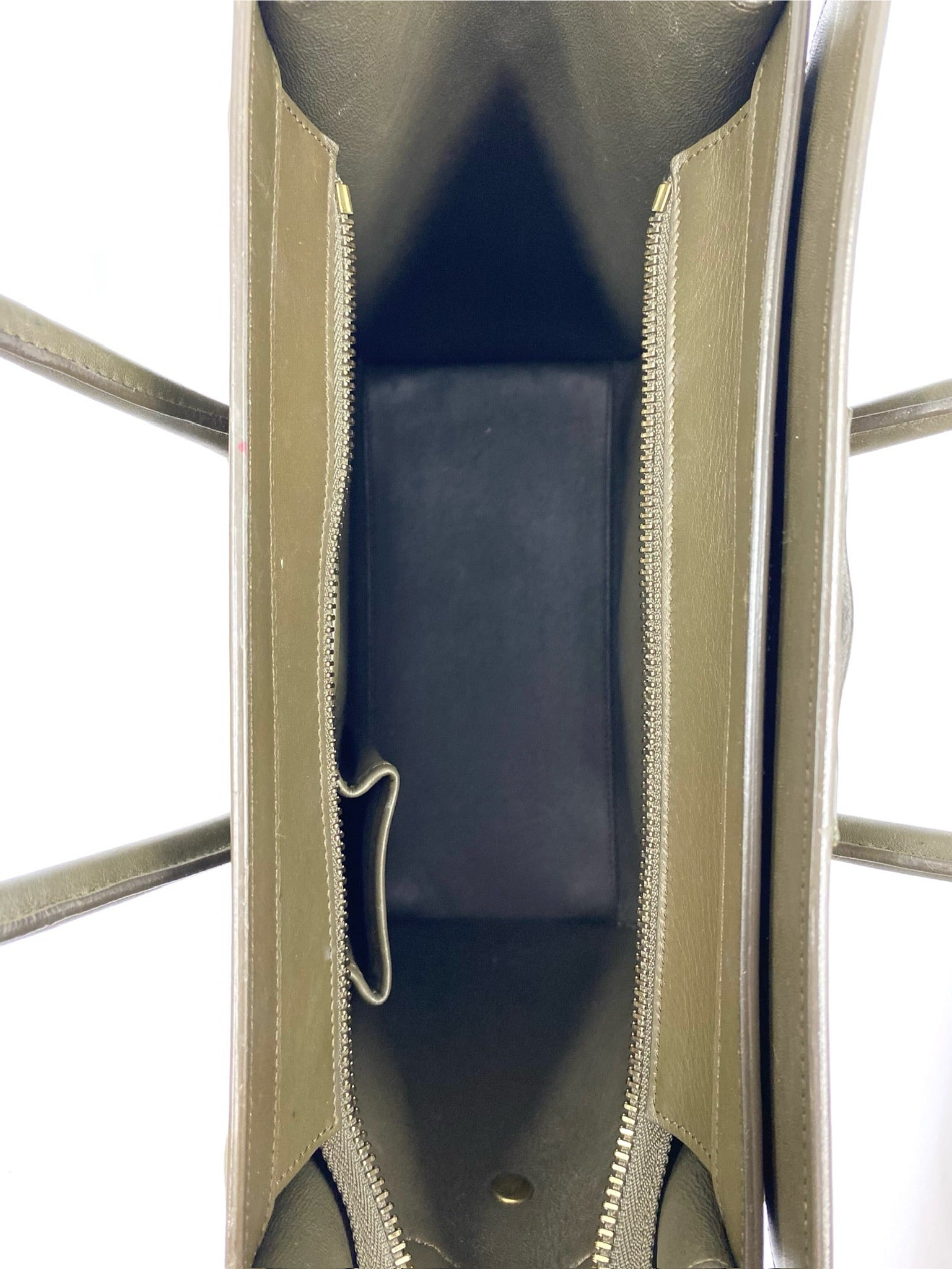 Celine Micro Luggage Tote in olive green calfskin, showing the black suede interior lining and top zip closure.