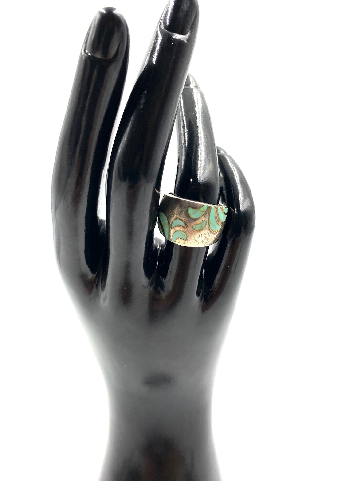 Chunky turquoise and sterling silver ring, size 6.5, with an etched leaf pattern on a black hand.