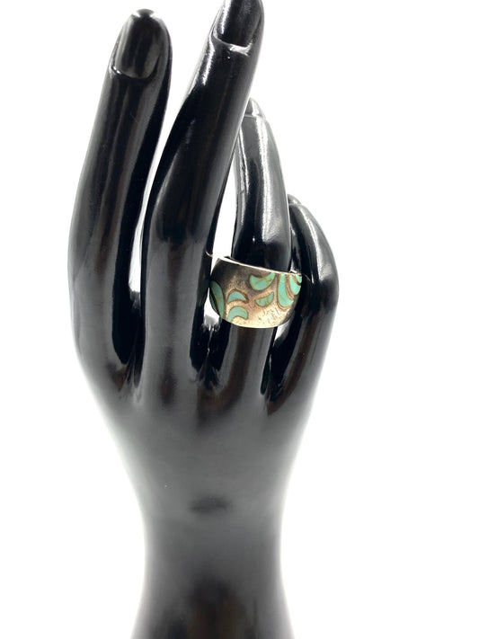 Chunky turquoise and sterling silver ring, size 6.5, with an etched leaf pattern on a black hand.