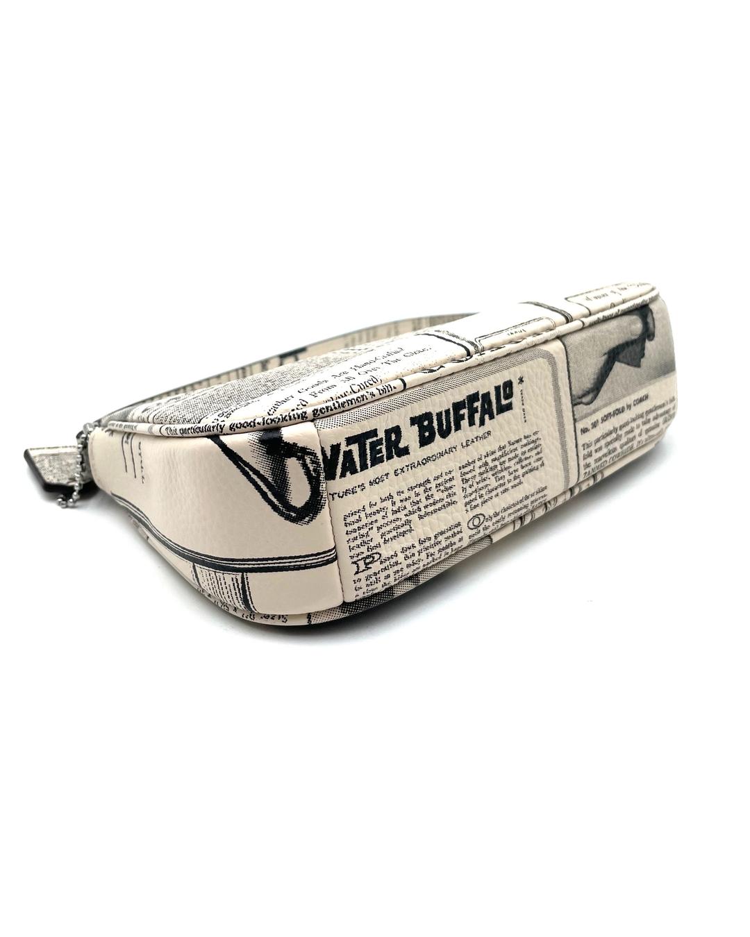 Coach Nolita 19 mini bag in cream pebble leather with a vintage black and white newspaper print design.