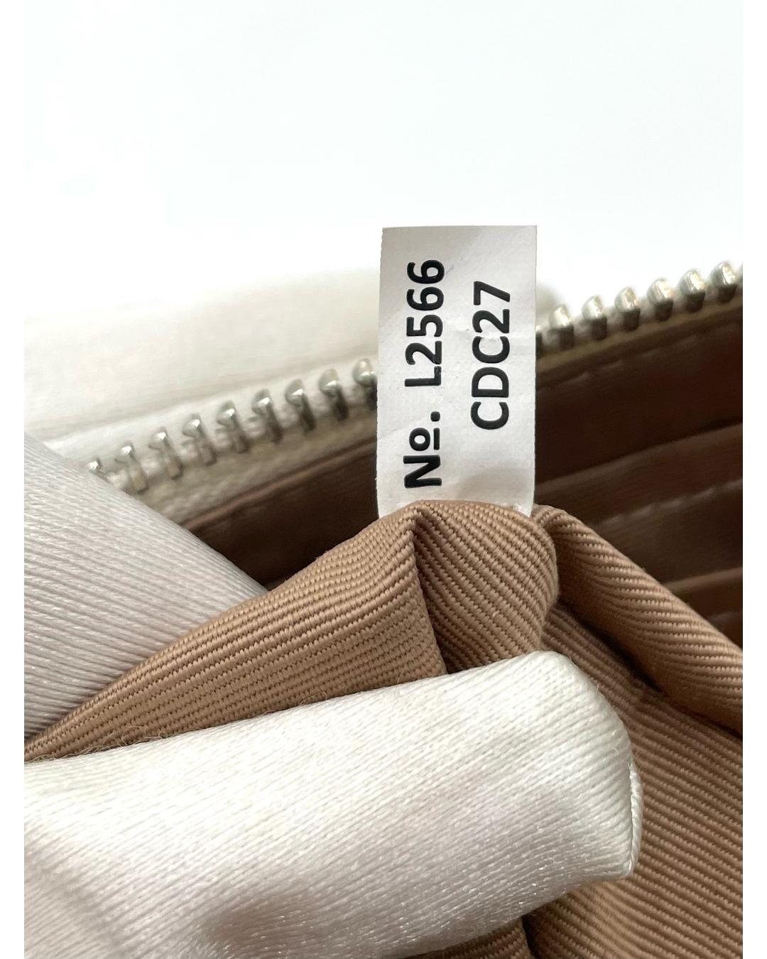 Coach Nolita 19 interior tag showing serial number L2566 CDC27 inside the beige fabric-lined bag.
