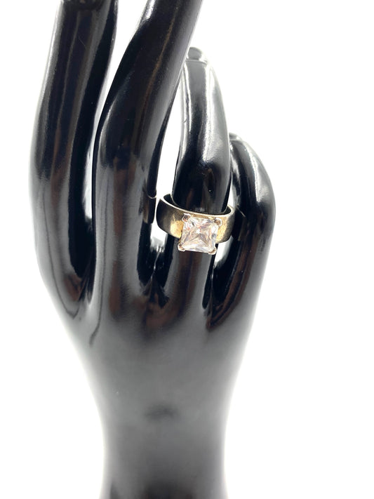 Sterling silver ring with a large, square cubic zirconia stone on a black display hand.