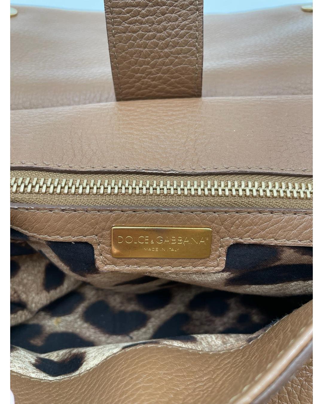 Interior of a caramel calfskin Dolce & Gabbana Miss Sicily bag with gold logo plaque and leopard print lining.