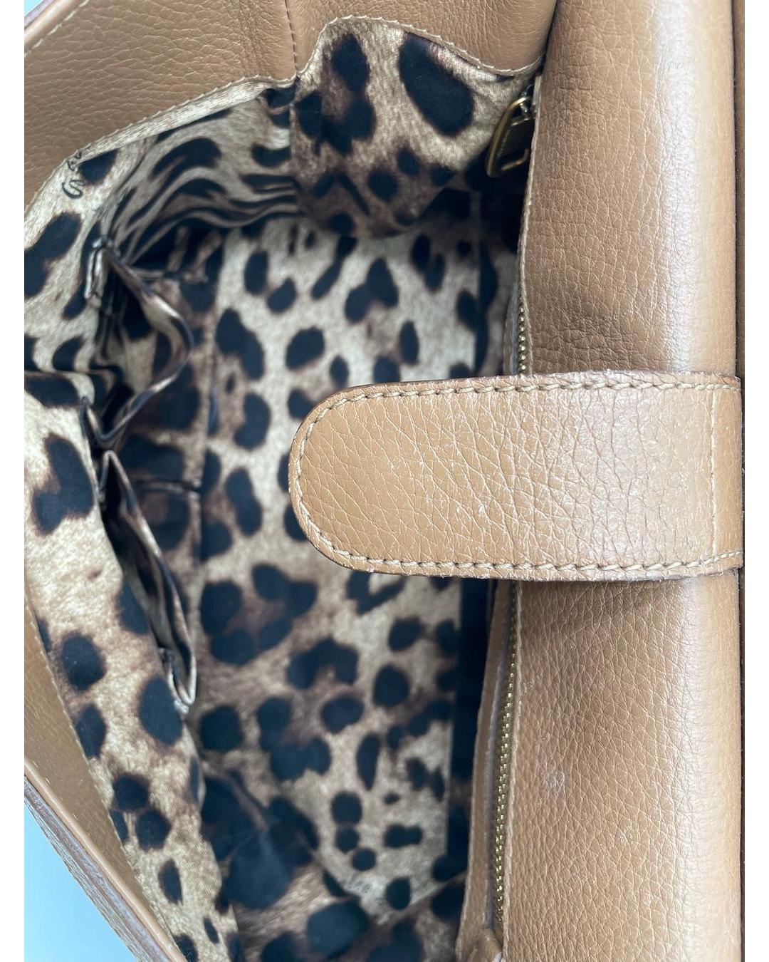 Interior of a caramel calfskin Dolce & Gabbana Miss Sicily bag with a leopard print lining and magnetic flap closure.