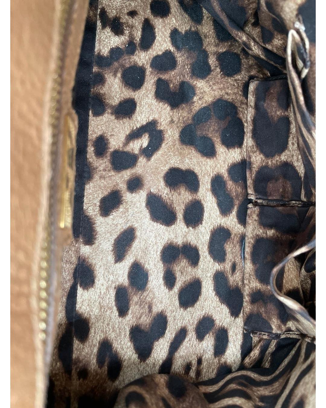 Interior of a Dolce & Gabbana Miss Sicily bag featuring a signature leopard print fabric lining and gold-tone hardware.