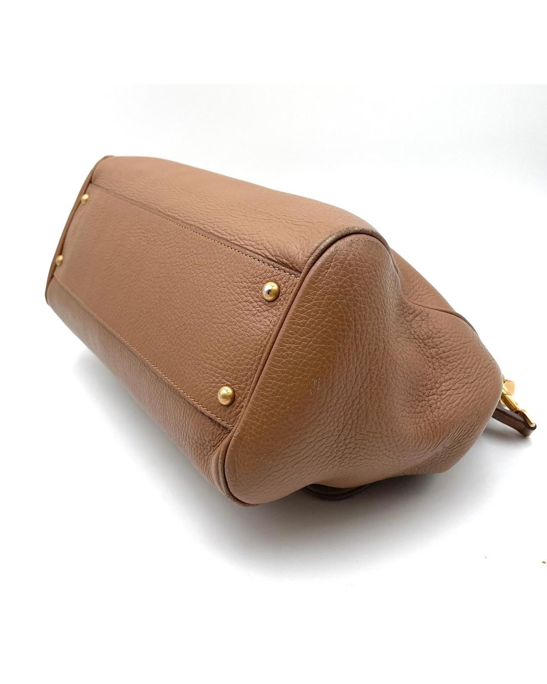 Caramel calfskin Dolce & Gabbana Miss Sicily bag, showing the textured leather base with protective gold metal feet.