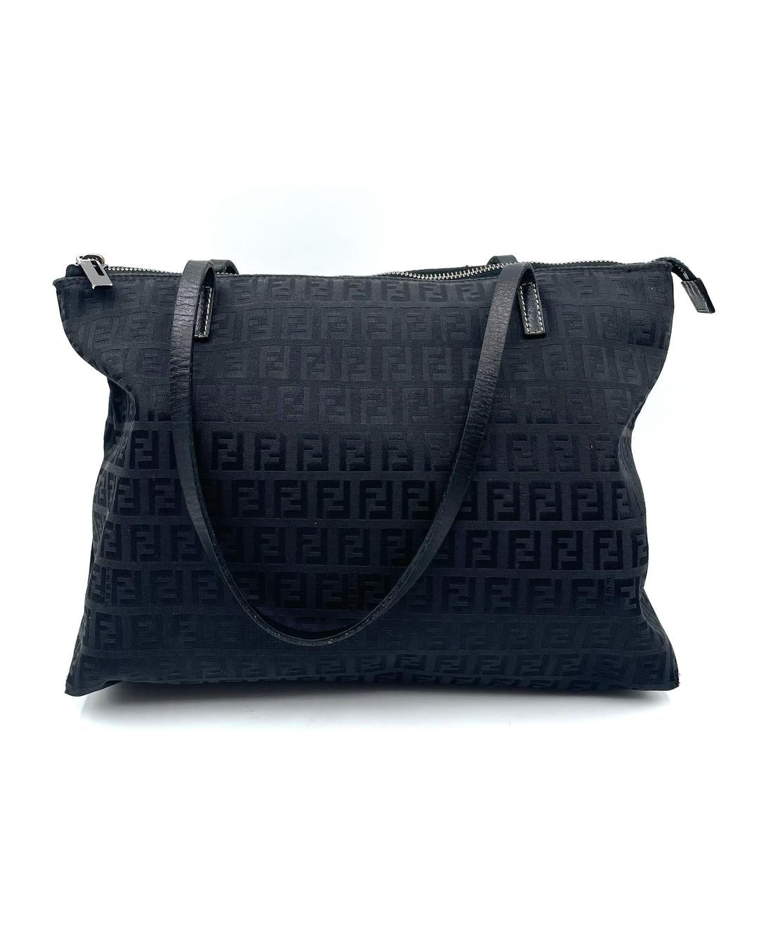 Vintage Fendi black Zucca monogram shoulder tote with top zip closure and leather straps.