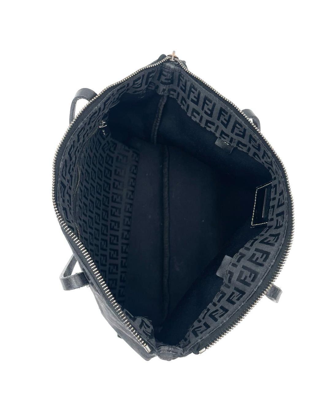 Interior view of a black Fendi Zucca monogram shoulder tote with a top zip closure and internal zip pocket.