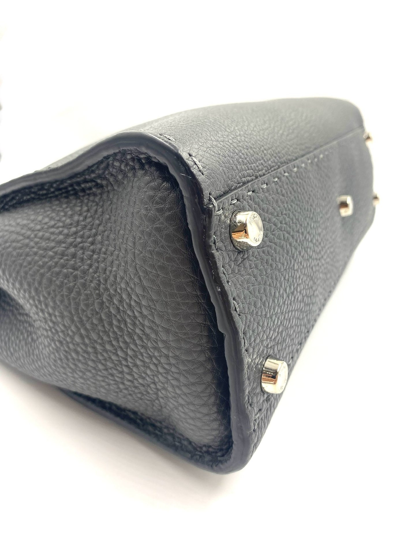 Bottom corner of a grey Selleria leather Fendi Peekaboo bag with silver-tone protective metal feet.