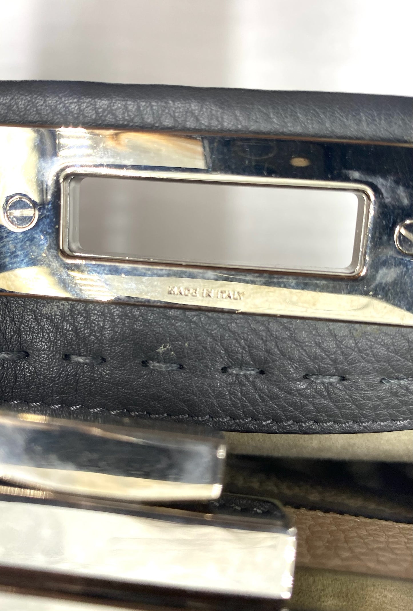 Close-up of Fendi Grey Selleria Leather Peekaboo bag's silver-tone hardware with "MADE IN ITALY" engraving.