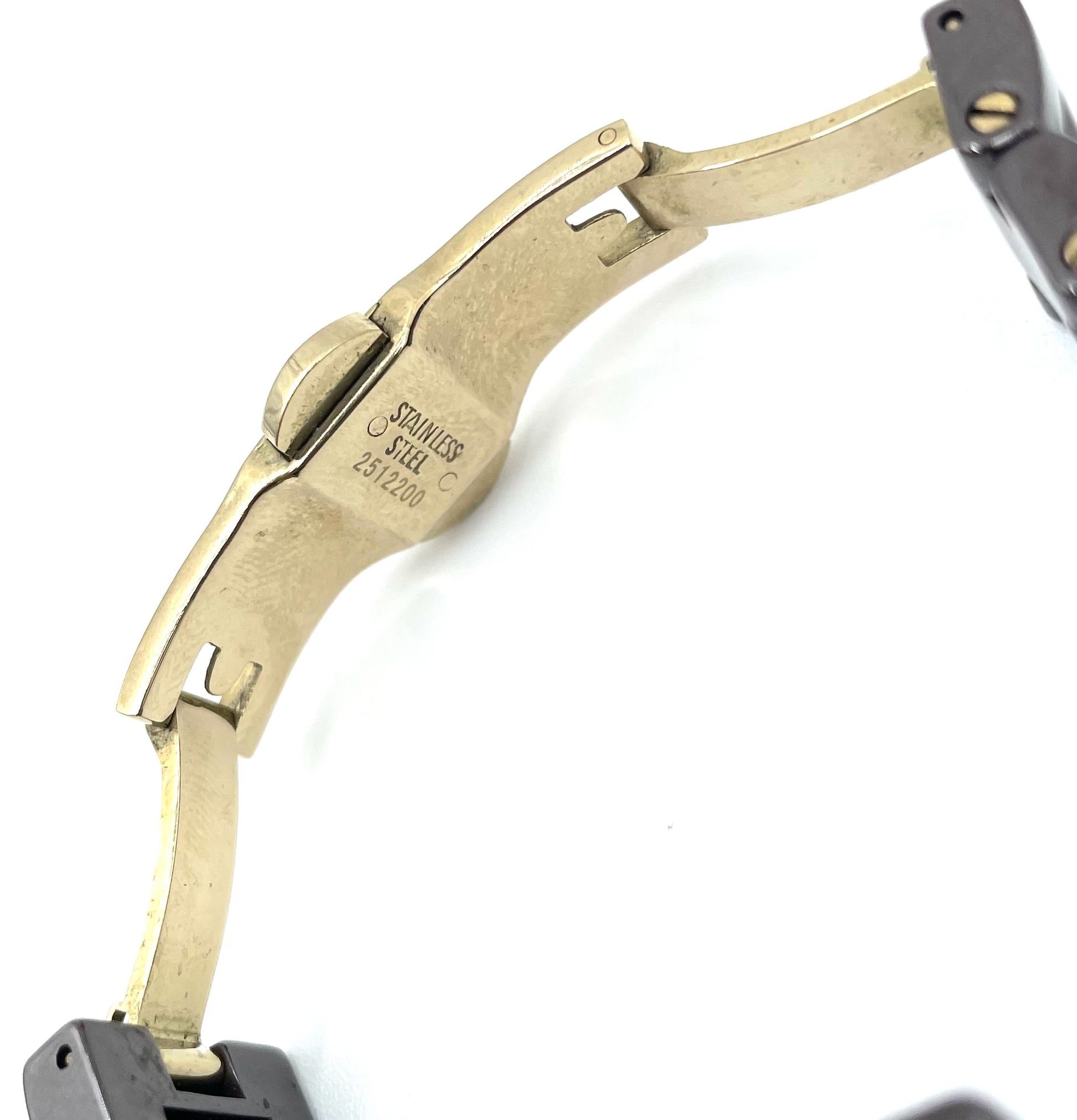 Underside of a Fossil Tortoise Watch CE1055 gold-tone stainless steel clasp with "STAINLESS STEEL C 2512200" engraving.