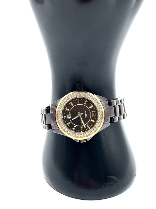 Fossil Tortoise Watch CE1055 with chocolate dial, crystal bezel, gold-tone accents, and glossy tortoise-style link bracelet.
