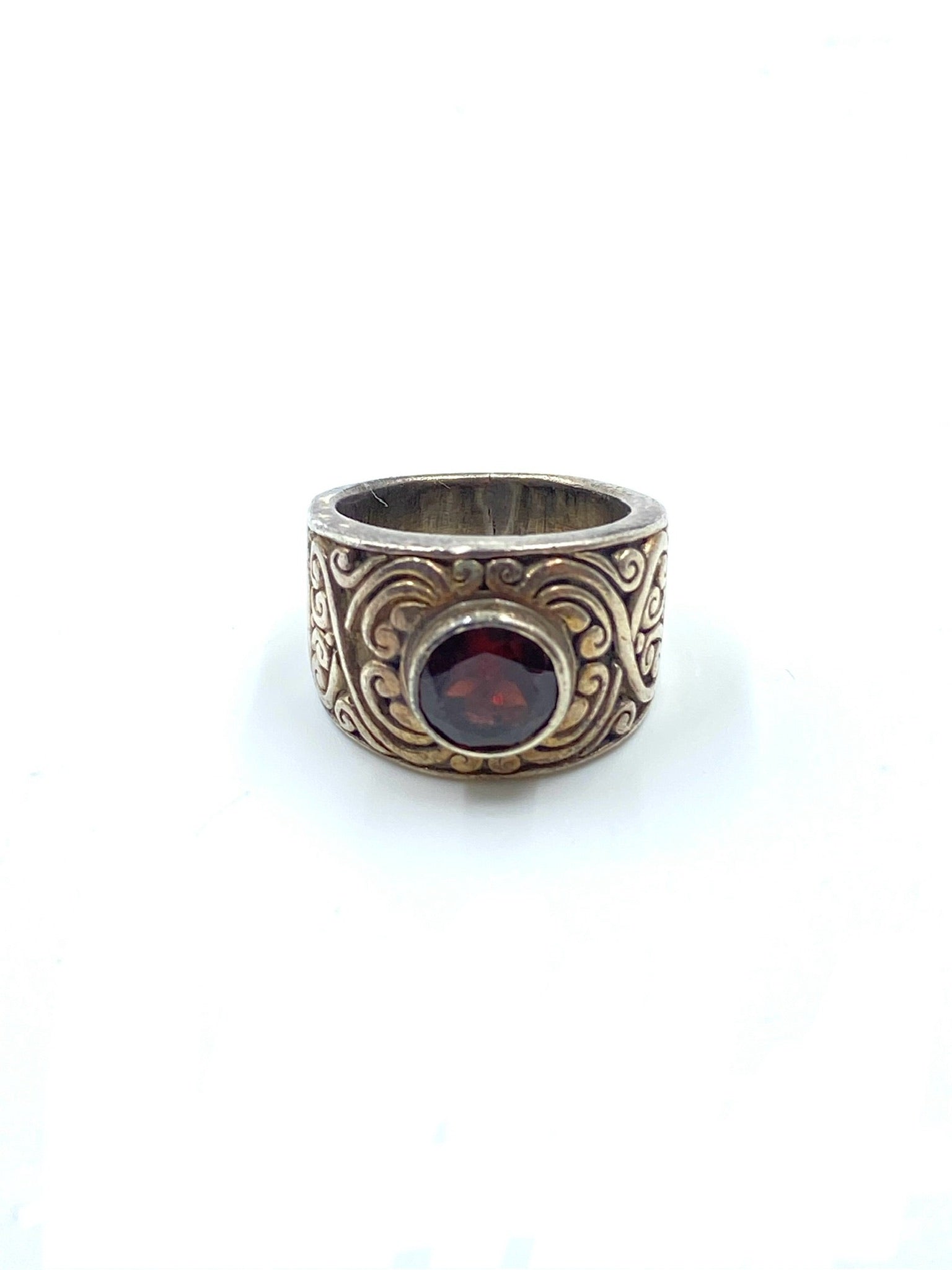Garnet sterling silver ring, size 6, with a wide band and intricate scrollwork design.
