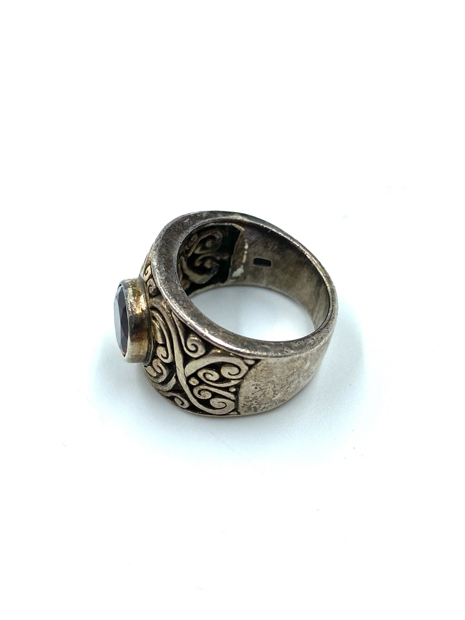 Garnet sterling silver ring, size 6, with a dark red stone and intricate scrollwork on a wide band.