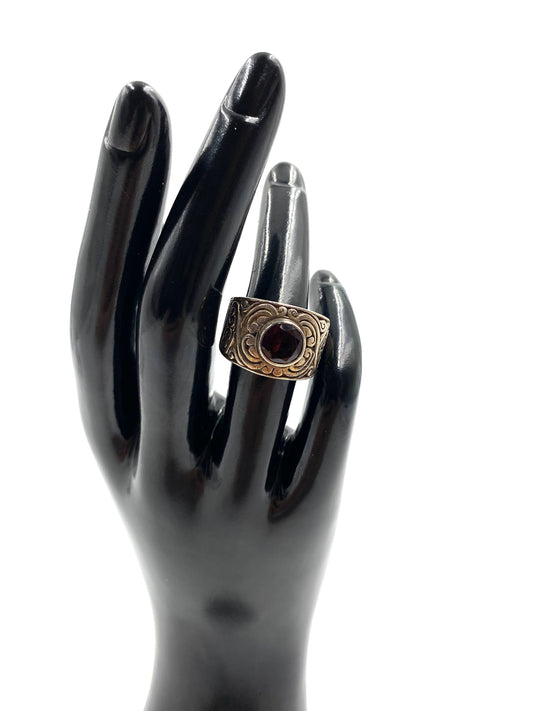 Garnet sterling silver ring size 6, featuring a dark red oval stone on a wide band with etched gold-tone accents.