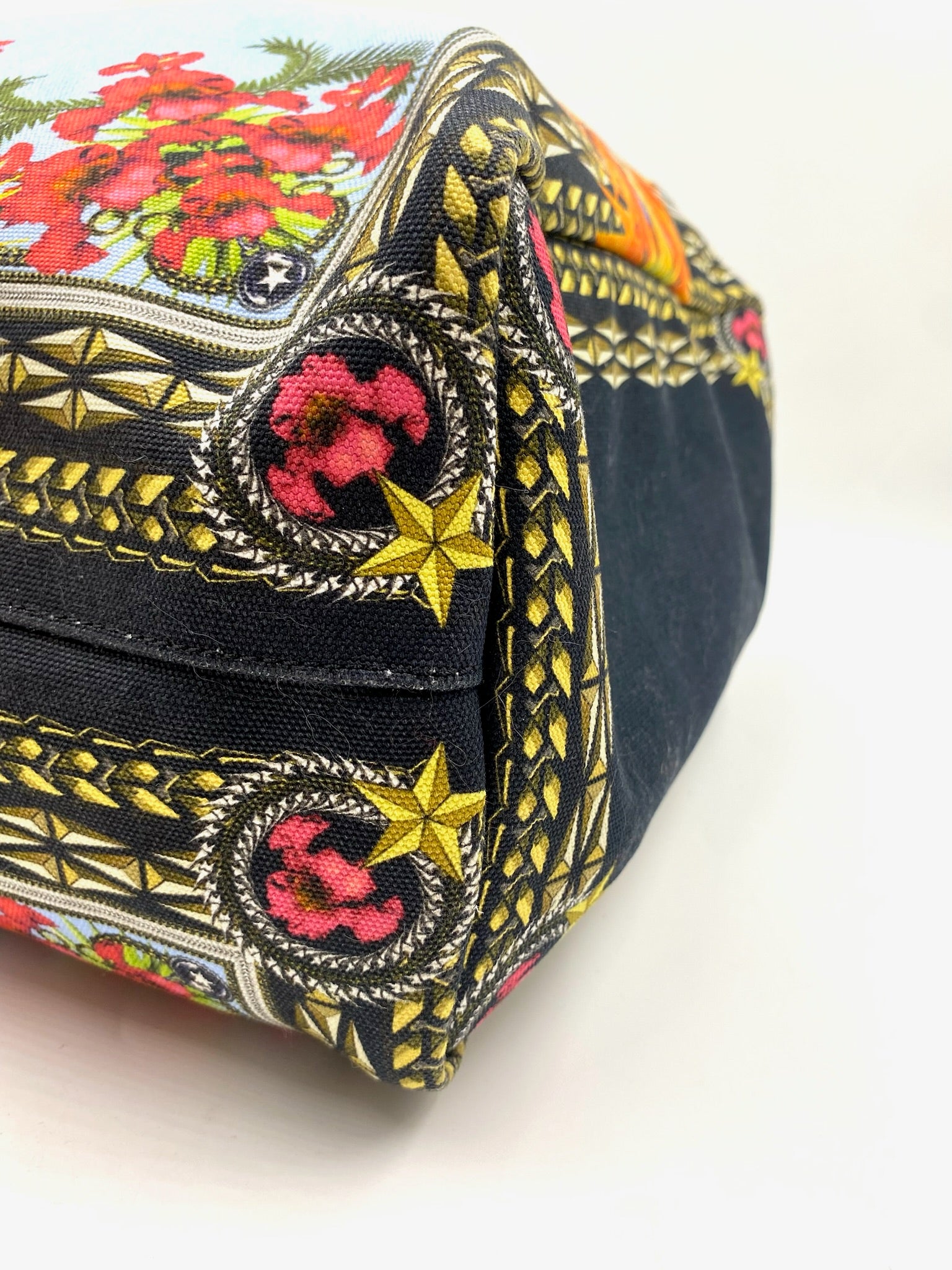 Givenchy Antigona Multicolor Printed Tote with floral and star patterns, black canvas base, and gold accents.