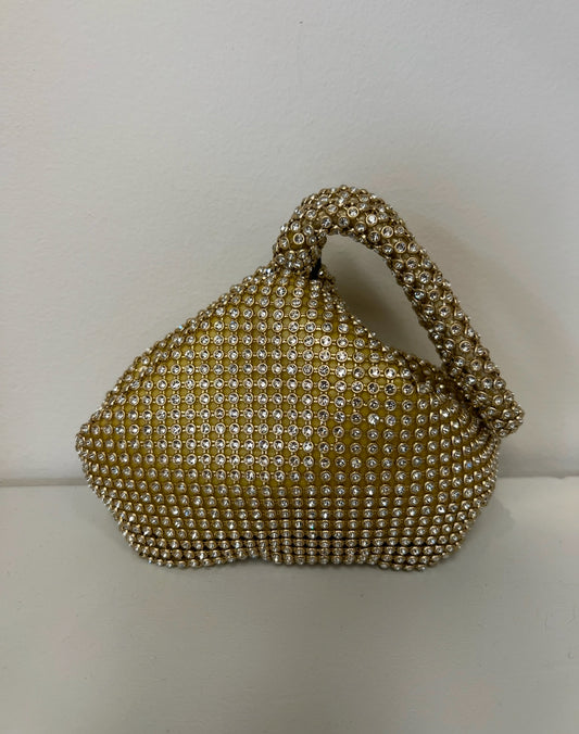 Gold mesh clutch covered in sparkling rhinestones with a structured top handle and unique sculptural shape.