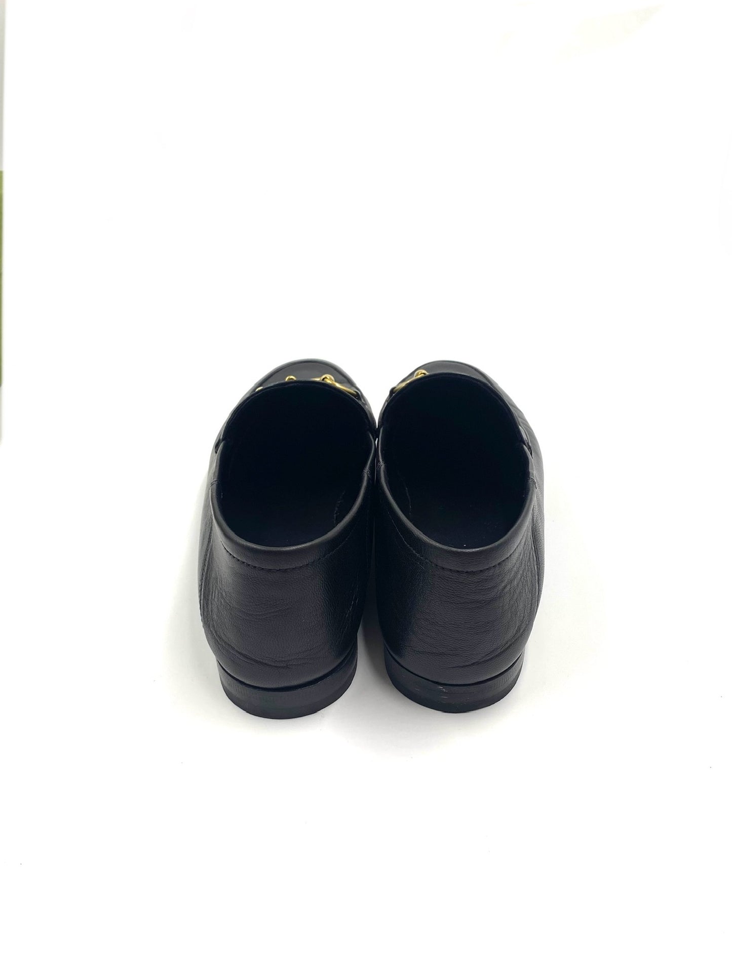 Gucci Black Jordaan loafers, size 37, with gold Horsebit detail, viewed from the back.