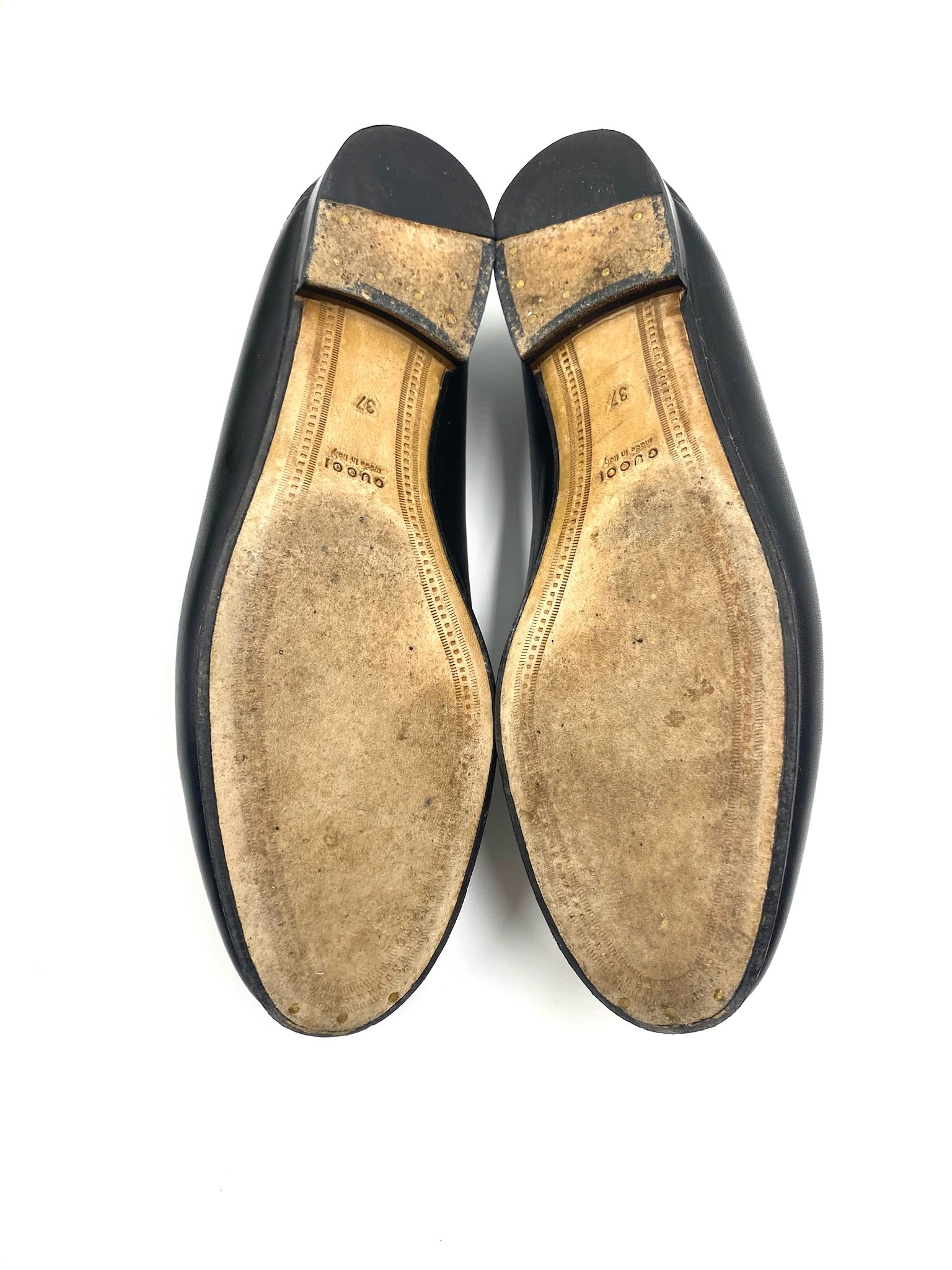 Gucci Black Jordaan Loafers size 37, showing worn soles with "Gucci Made in Italy" stamp.