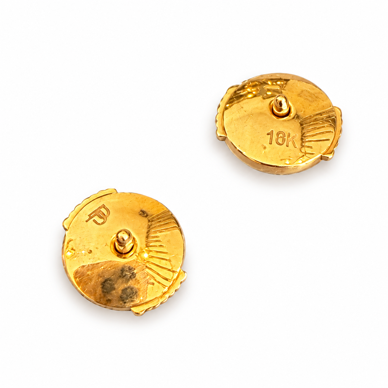 Back view of two round 18k yellow gold earring screw-backs with engraved 10K hallmark and designer branding.