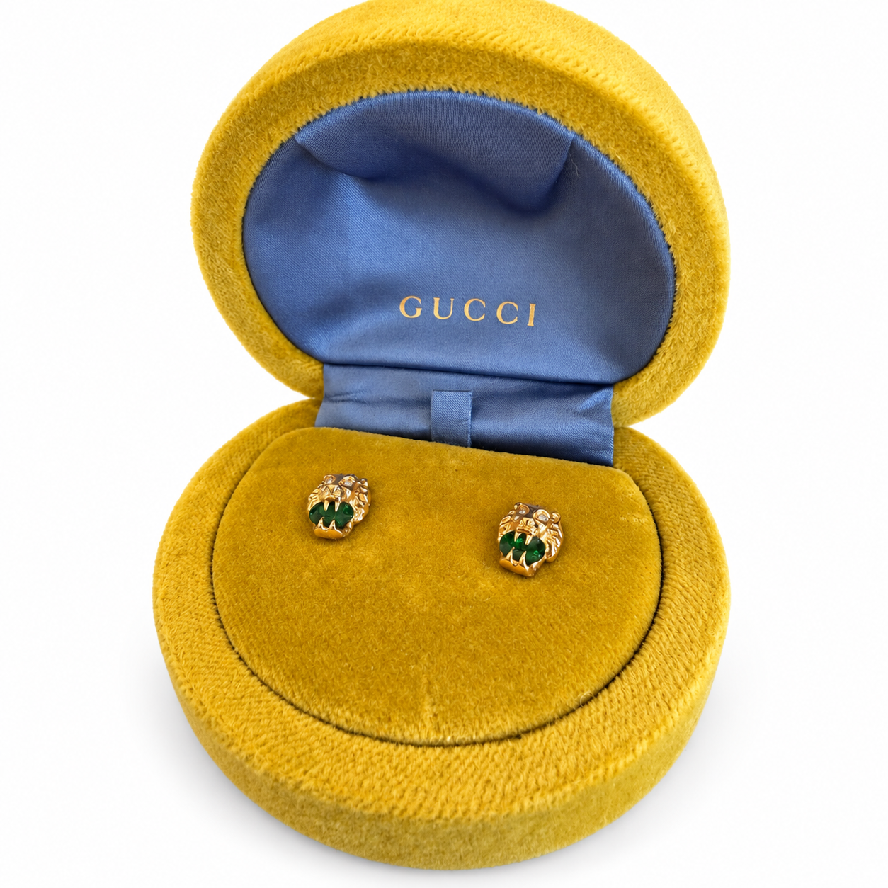 Gucci 18k gold lion head stud earrings with green diopside and diamond accents in a yellow velvet display box.